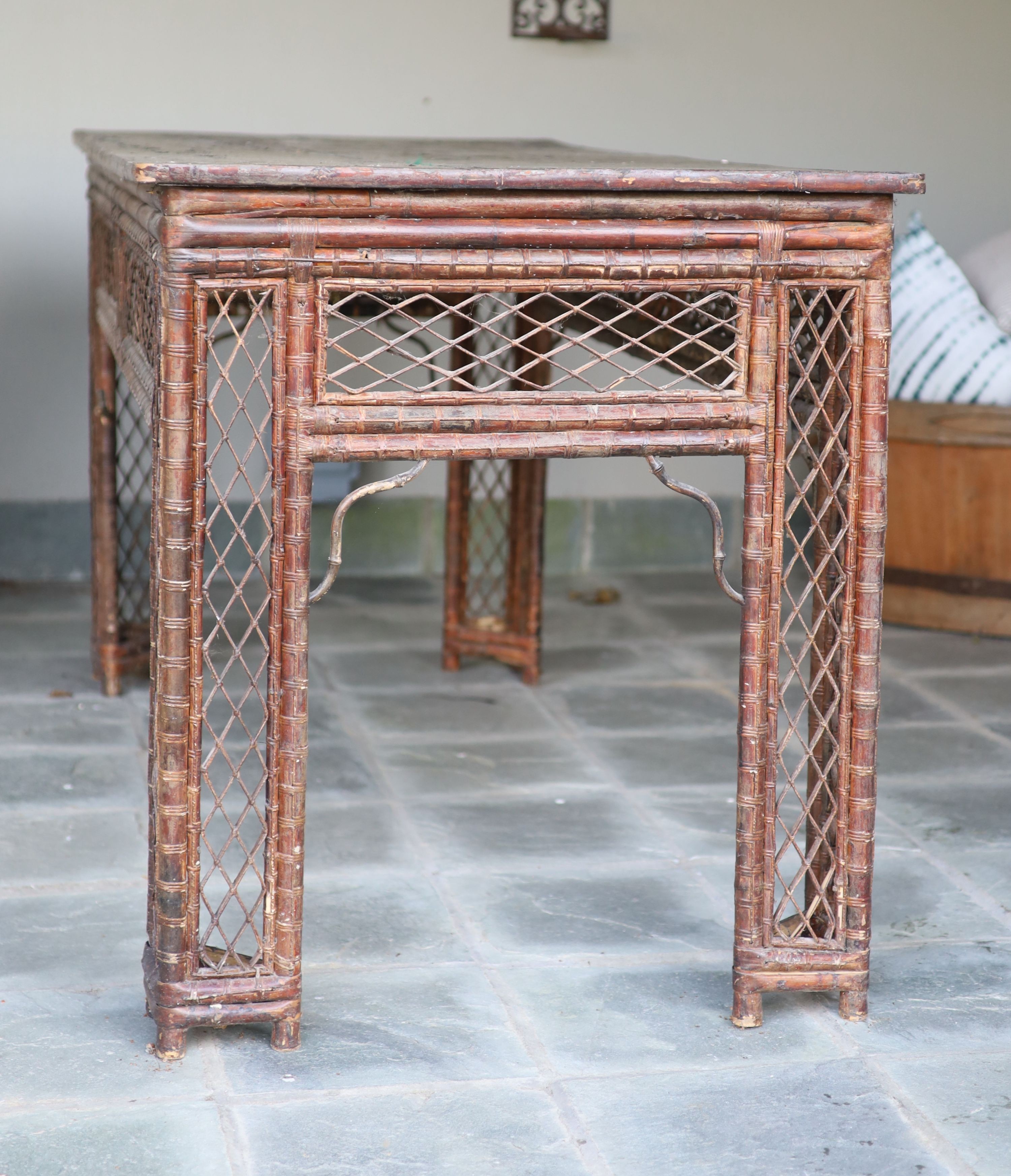 A bamboo and rattan centre table, with black lacquered top, width 166cm depth 76cm height 86cm